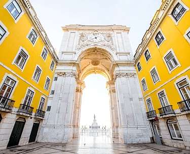 Blick auf den Triumphbogen auf dem Handelsplatz bei Sonnenaufgang in Lissabon, Portugal
