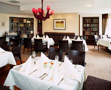 Blick auf eine Gastsstube mit dunklen Stühlen