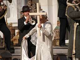 Das Stück Jedermann mit einer Schauspielerin, die ein Kreuz trägt